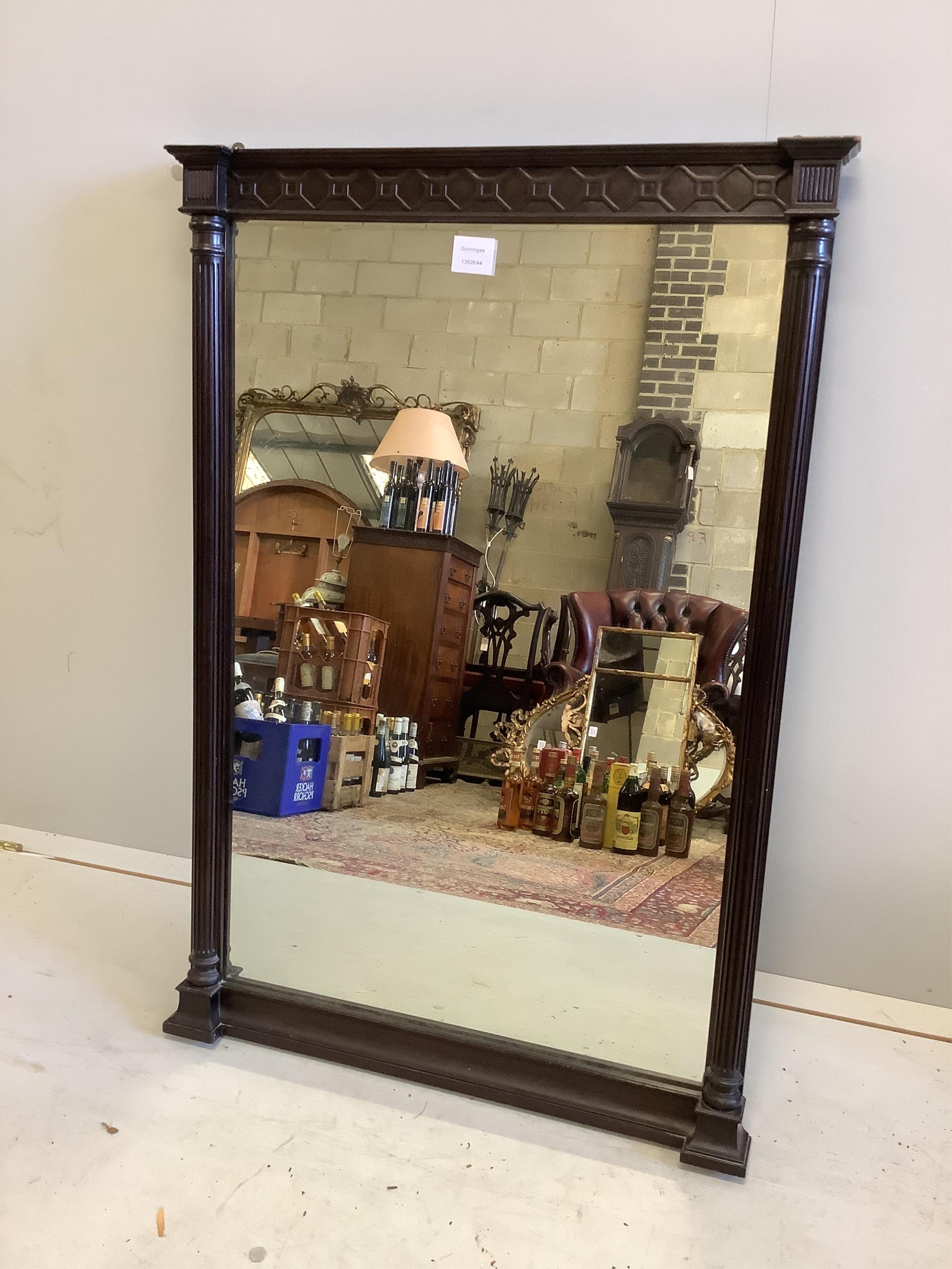 An Edwardian mahogany wall mirror with fluted pilasters and shallow carved frieze, width 64cm, height 95cm